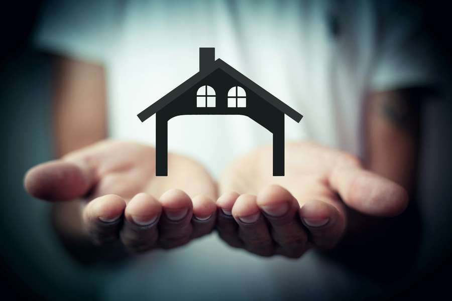 House symbol held in protective hands